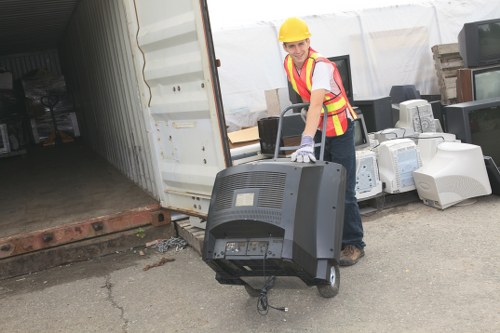 Furniture and electronics being removed during office clearance